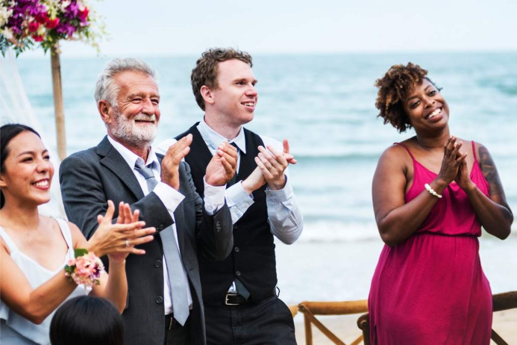 Wedding guests clapping for the bride and groom